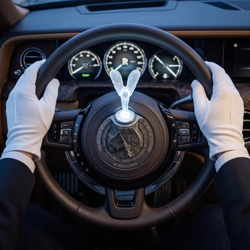 White-gloved chauffeur at a Rolls-Royce wheel with crystal Spirit of Ecstasy